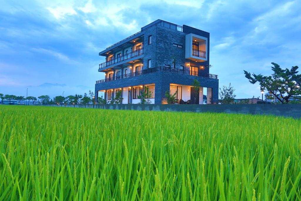 a house in the middle of a rice field at Qi Li Xiang Homestay in Wujie