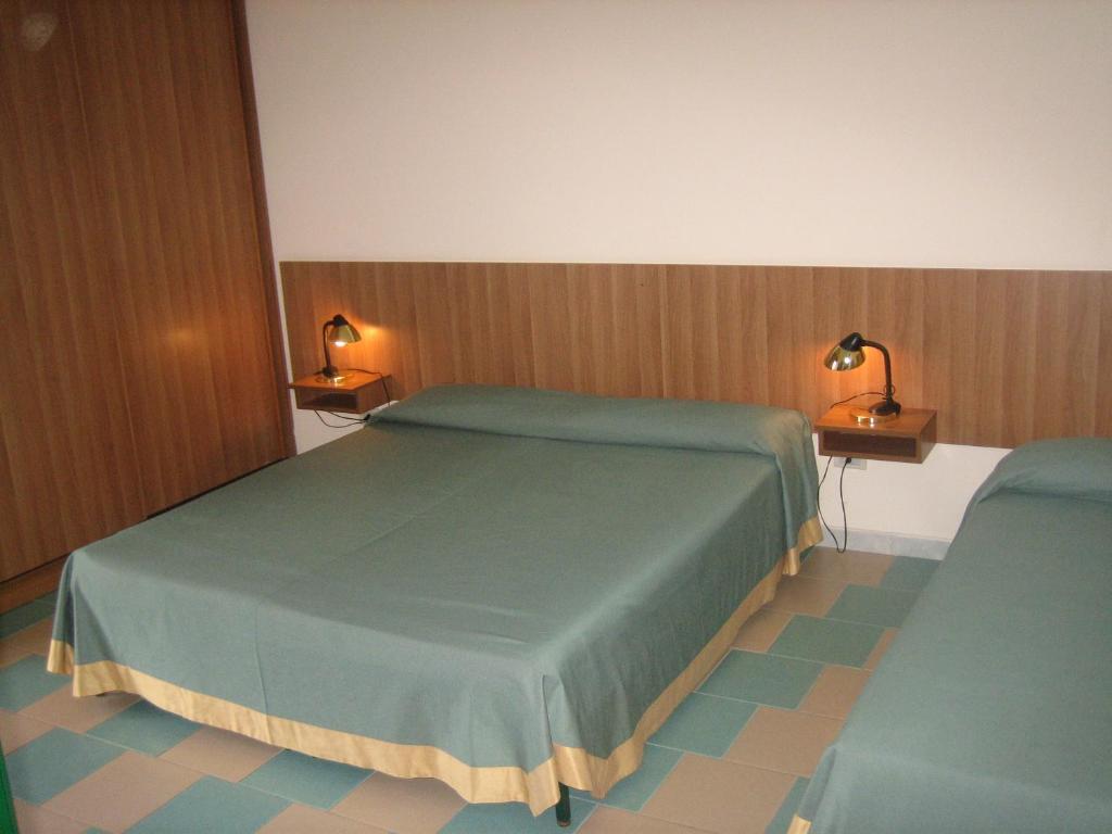 Postel nebo postele na pokoji v ubytování Hotel Kennedy