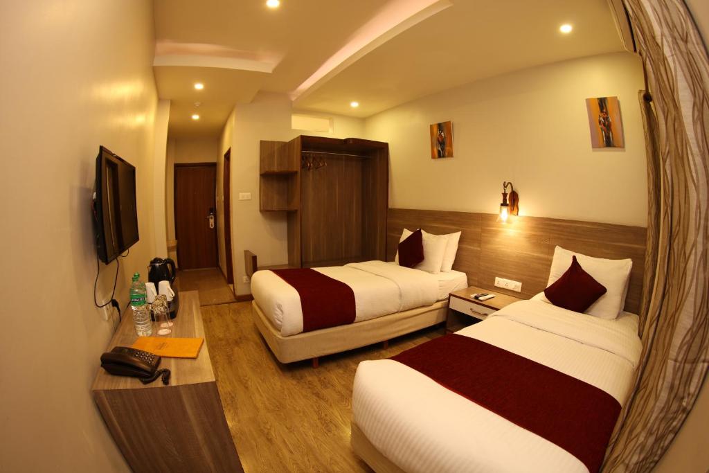 Postel nebo postele na pokoji v ubytování Hotel Arts Kathmandu