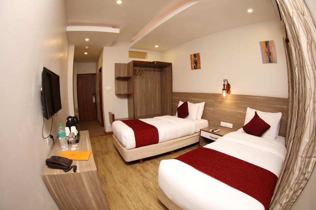 Postel nebo postele na pokoji v ubytování Hotel Arts Kathmandu