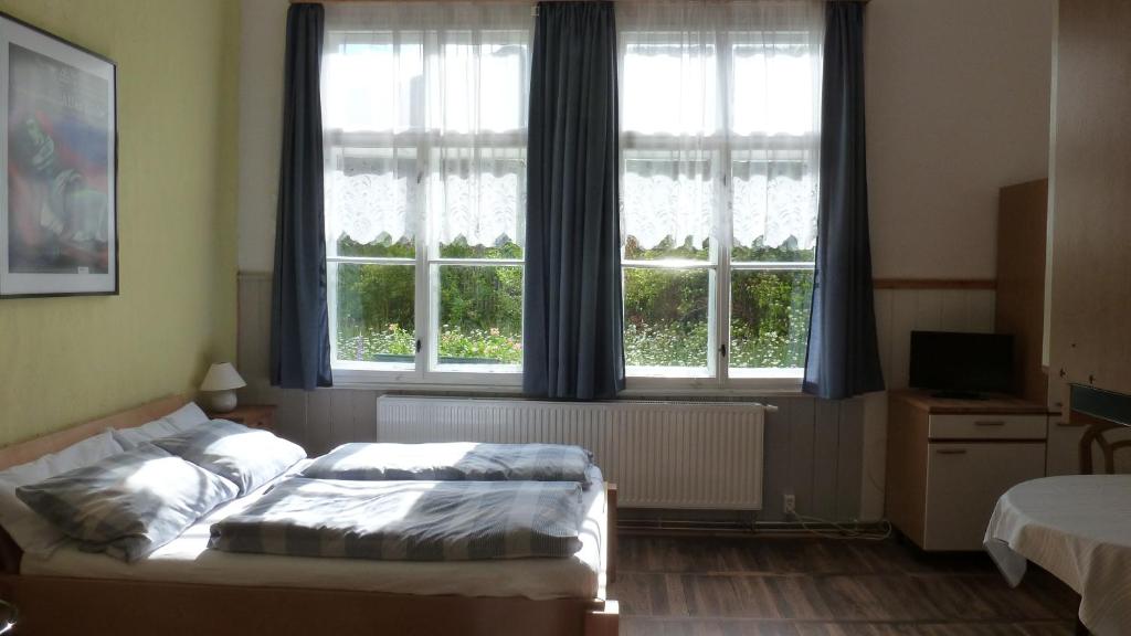 a bedroom with a bed in front of a window at Alte Schule in Tambach-Dietharz