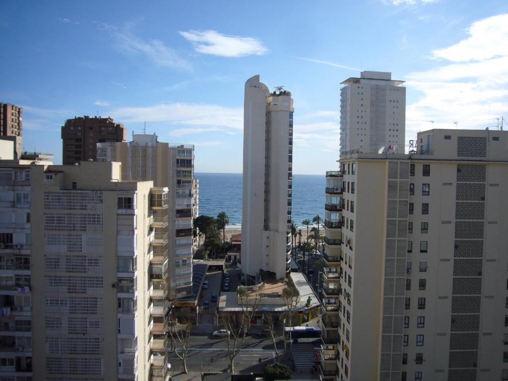 a view of a city with tall buildings and the ocean at Los Pinos - Fincas Arena in Benidorm