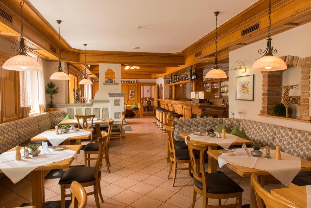 a restaurant with tables and chairs in a room at Hotel & Gasthof Richard Held in Regensburg