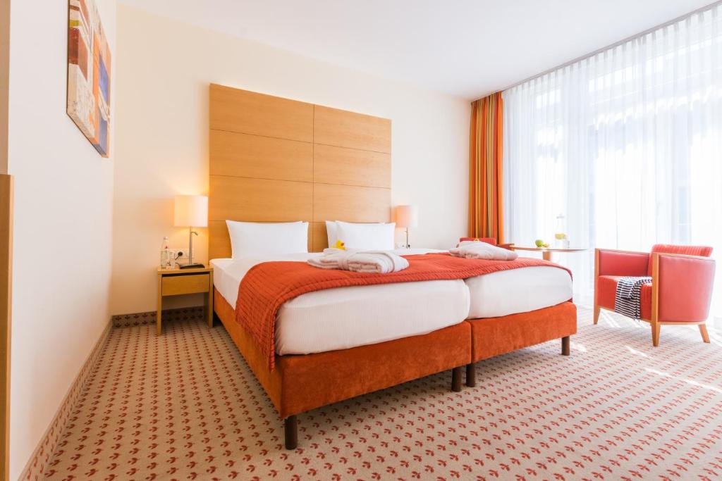 Postel nebo postele na pokoji v ubytování Park-Hotel Hübner