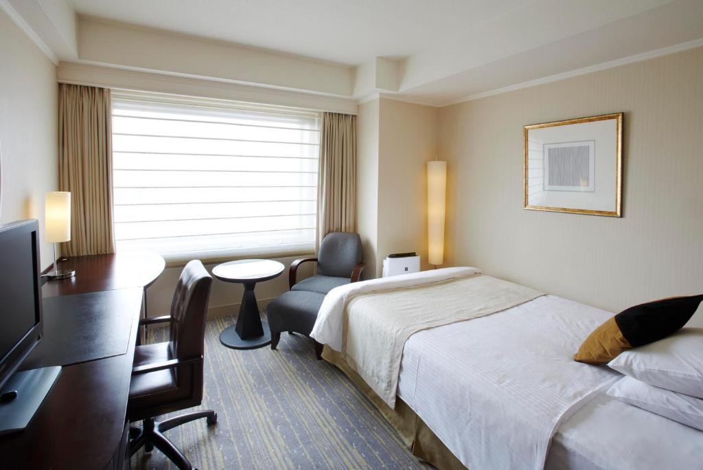 Postel nebo postele na pokoji v ubytování Royal Park Hotel
