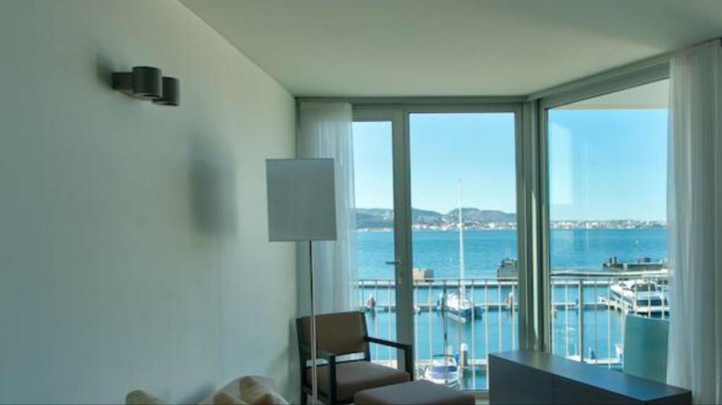 a room with a room with a view of the ocean at Troia Resort Apt Marina in Troia