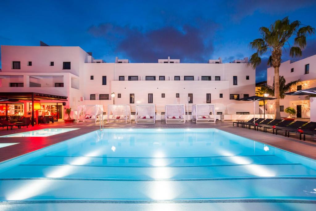 a large swimming pool in a hotel room at Migjorn Ibiza Suites & Spa in Playa d'en Bossa