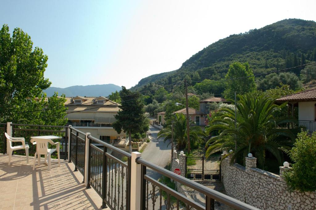 a balcony with a view of a town with mountains at Geroulis Stefanos Studios in Vasiliki