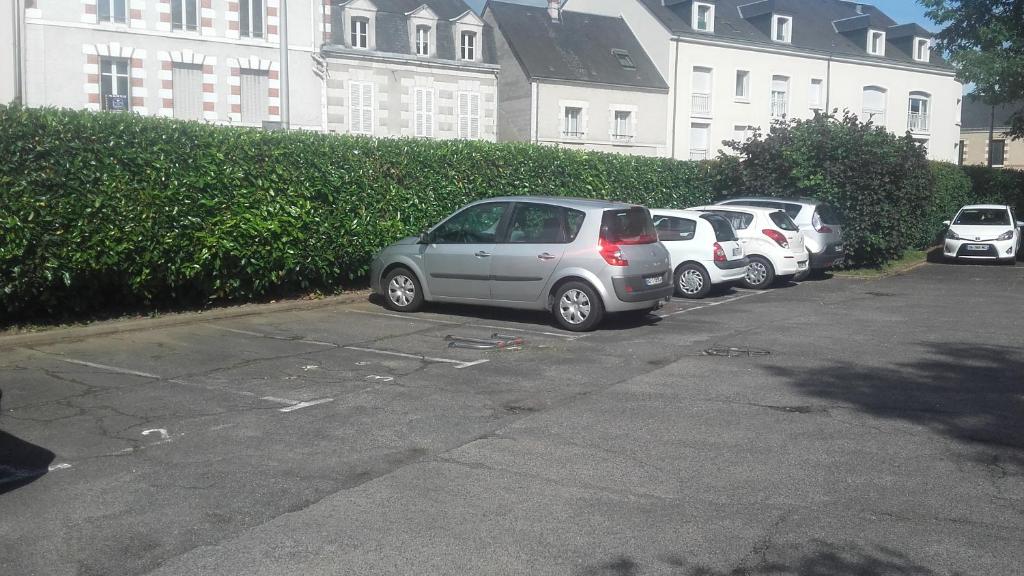 a row of parked cars in a parking lot at L&#39;appartement du Haut Plessis in Blois