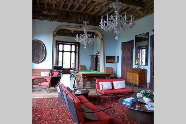 ヴァレーゼにあるVilla Il Nonaroのリビングルーム(赤い家具、テーブル付)
