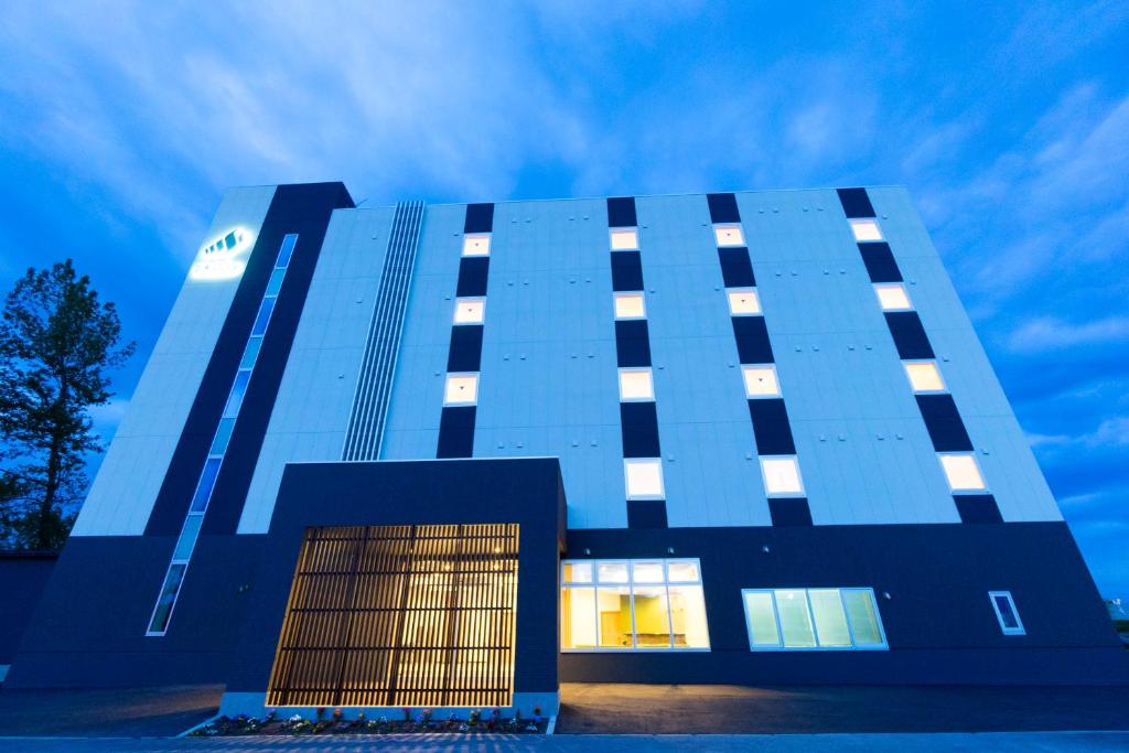 a tall blue building with a blue at Mikasa Tennen Onsen Taikonoyu Sparesort Hotel Taiko Bettei Hatago in Iwamizawa