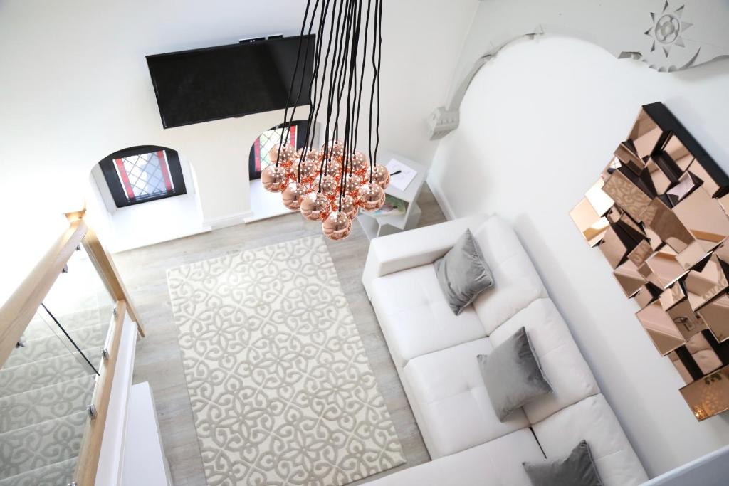 an overhead view of a living room with white furniture at The Chapel Chester - Boutique Apartments in Chester