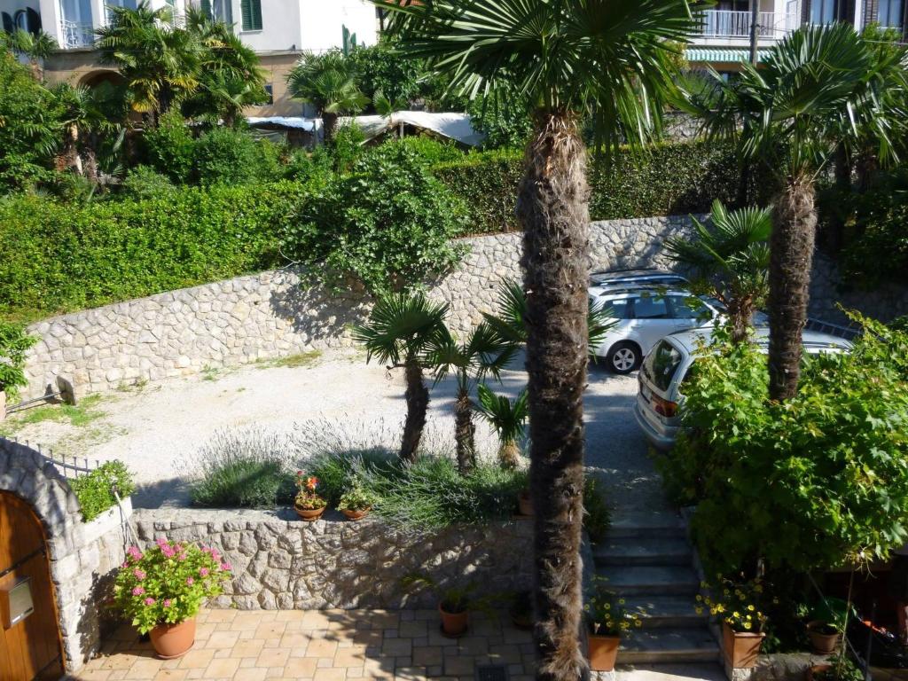 a view of a parking lot with palm trees at Apartments Hortensia in Opatija