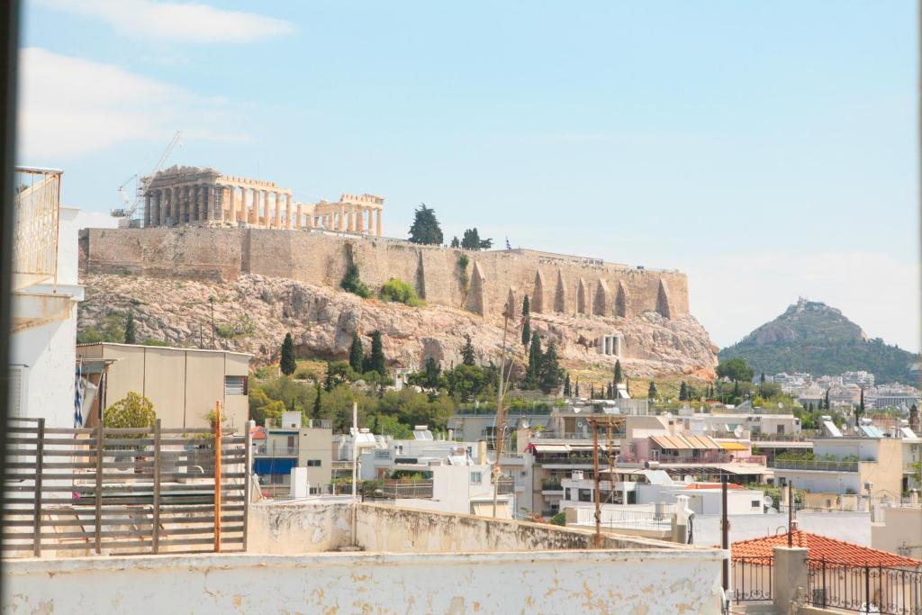 a view of a city with a hill in the background at Mind-blowing Acropolis View Apt in Athens