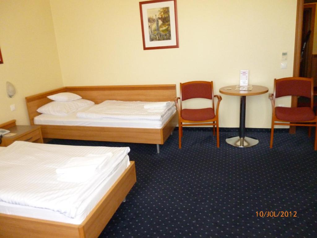 Ένα ή περισσότερα κρεβάτια σε δωμάτιο στο Hotel Paprika
