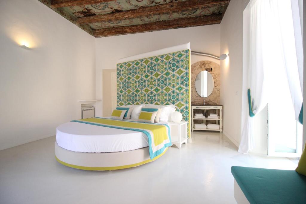 a bedroom with a large bed in a room at I Soffitti Dimora Esclusiva in Tropea
