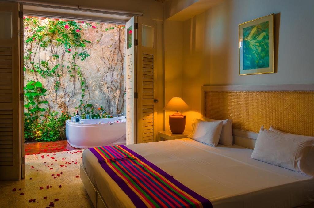 Een bed of bedden in een kamer bij Casa Pizarro Hotel Boutique