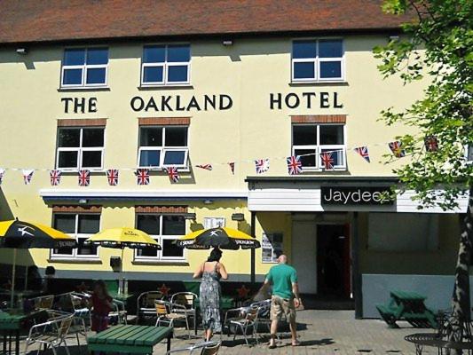 dos hombres parados frente a un hotel en The Oakland Hotel en Woodham Ferrers