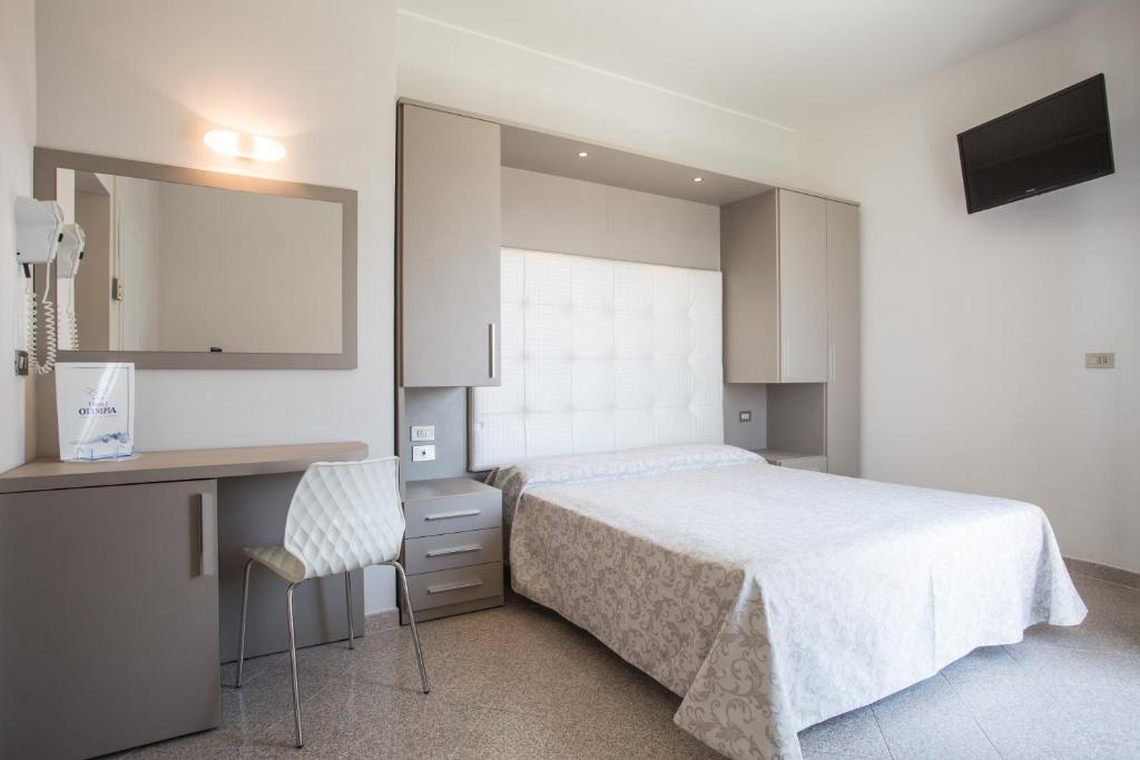Postel nebo postele na pokoji v ubytování Hotel Olympia