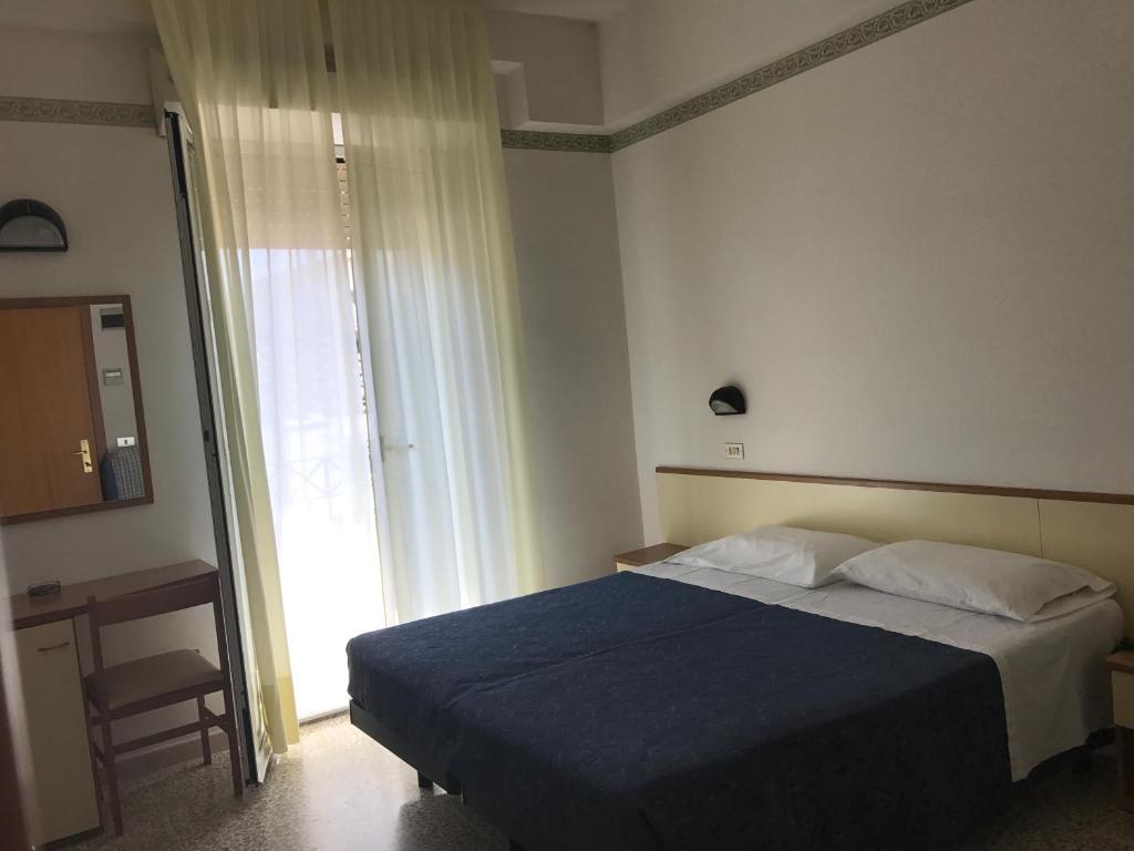 Postel nebo postele na pokoji v ubytování Hotel Luciana