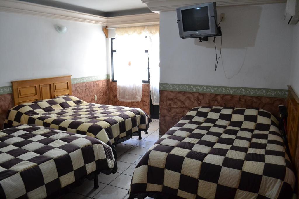Postel nebo postele na pokoji v ubytování Hotel Senorial