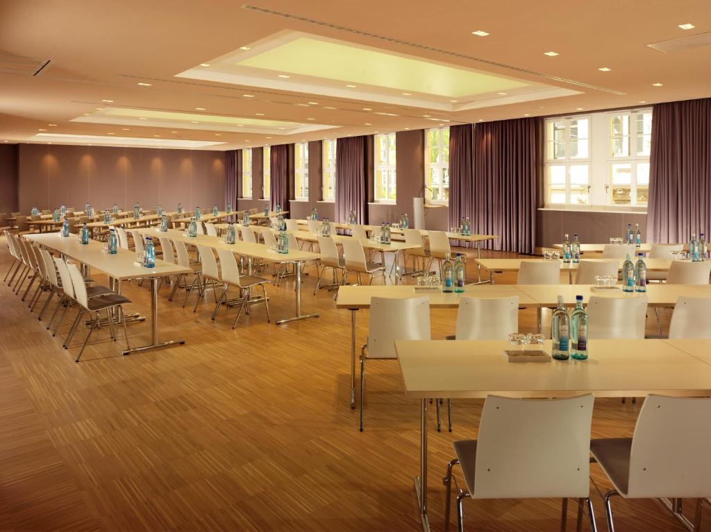 a large banquet hall with tables and chairs at HYPERION Hotel Dresden Am Schloss in Dresden