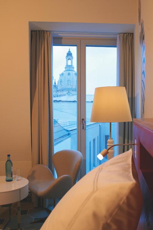 a hotel room with a view of the building at HYPERION Hotel Dresden Am Schloss in Dresden
