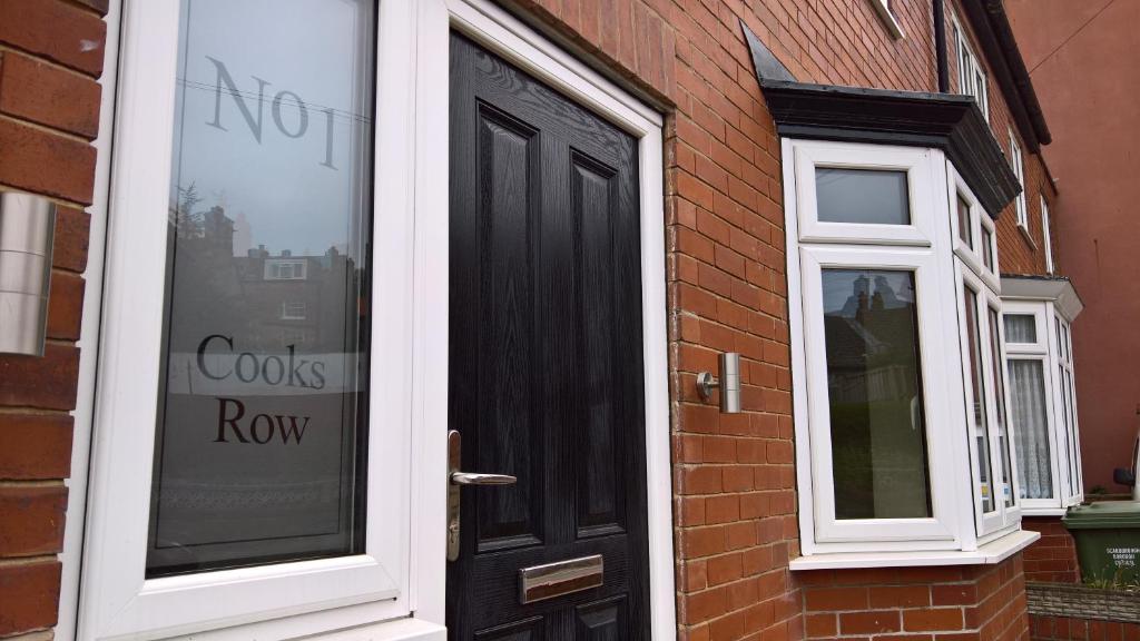 a black door with a sign that says costs row at Cooks Row in Scarborough