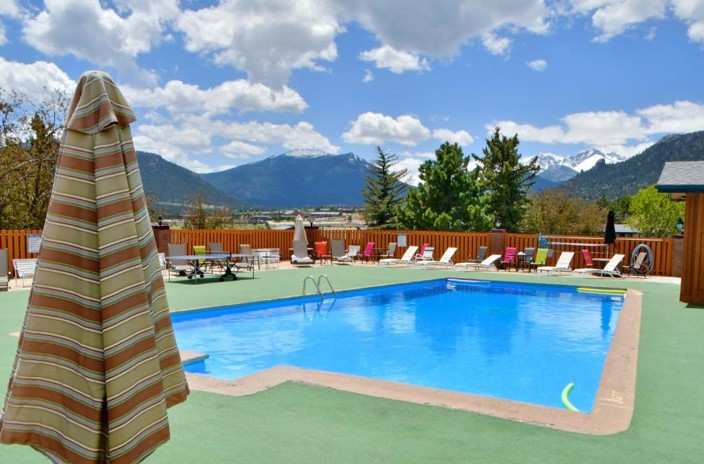 a swimming pool with mountains in the background at Murphy's Resort in Estes Park