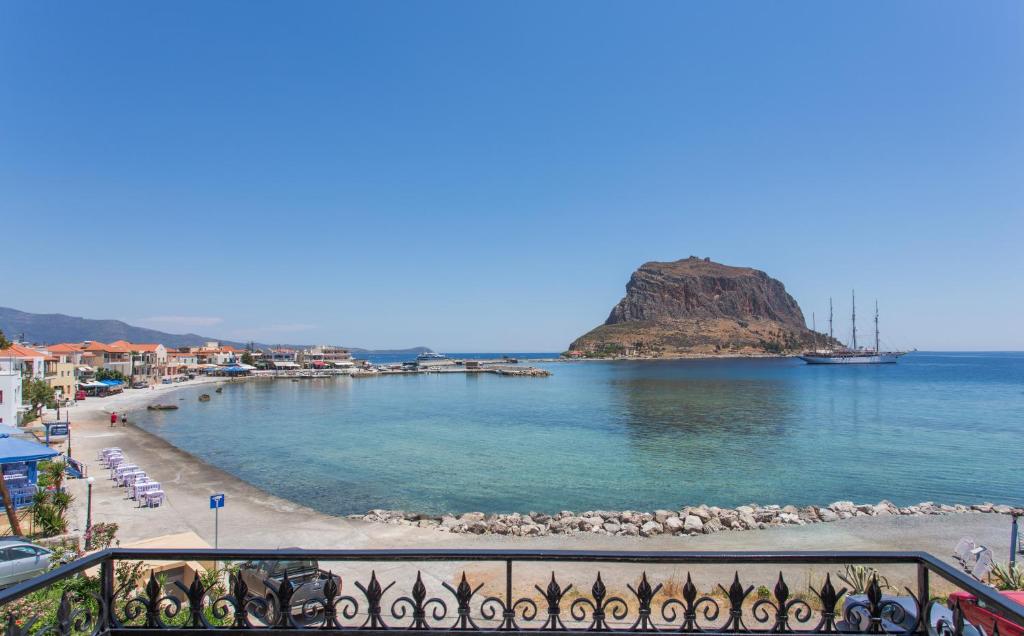 a view of a beach from a balcony at Petrino Guesthouse in Monemvasia