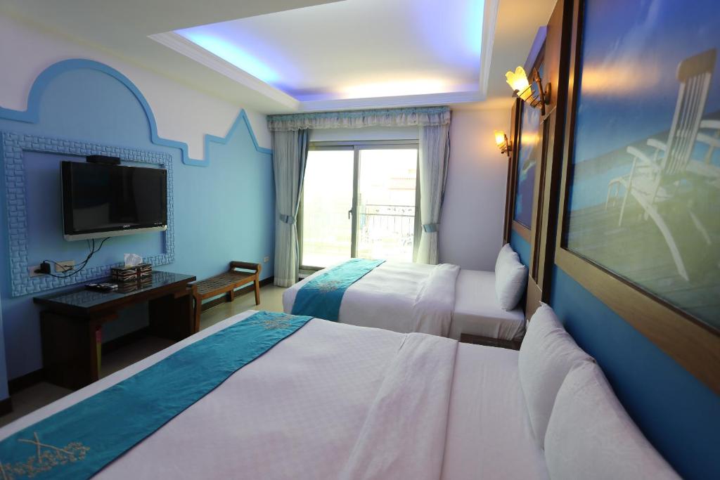 Postel nebo postele na pokoji v ubytování 墾丁貝殼灣旅店