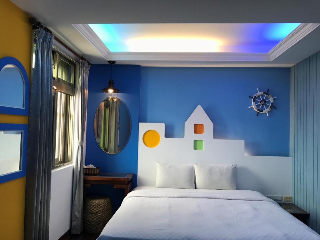 Postel nebo postele na pokoji v ubytování 墾丁貝殼灣旅店