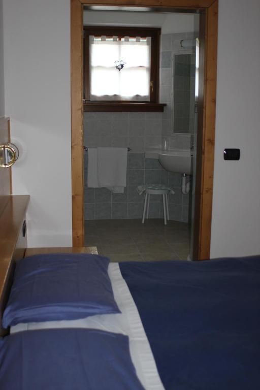 Albergo alla Postaにあるベッド