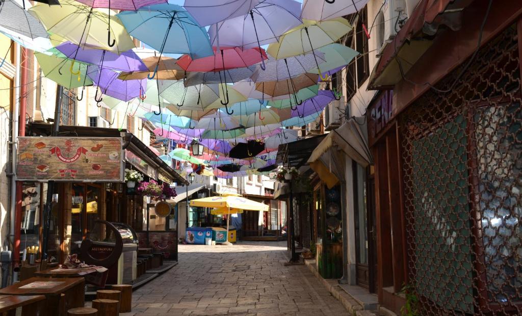 an alley with umbrellas hanging from a ceiling at Hotel Ultra Star in Skopje