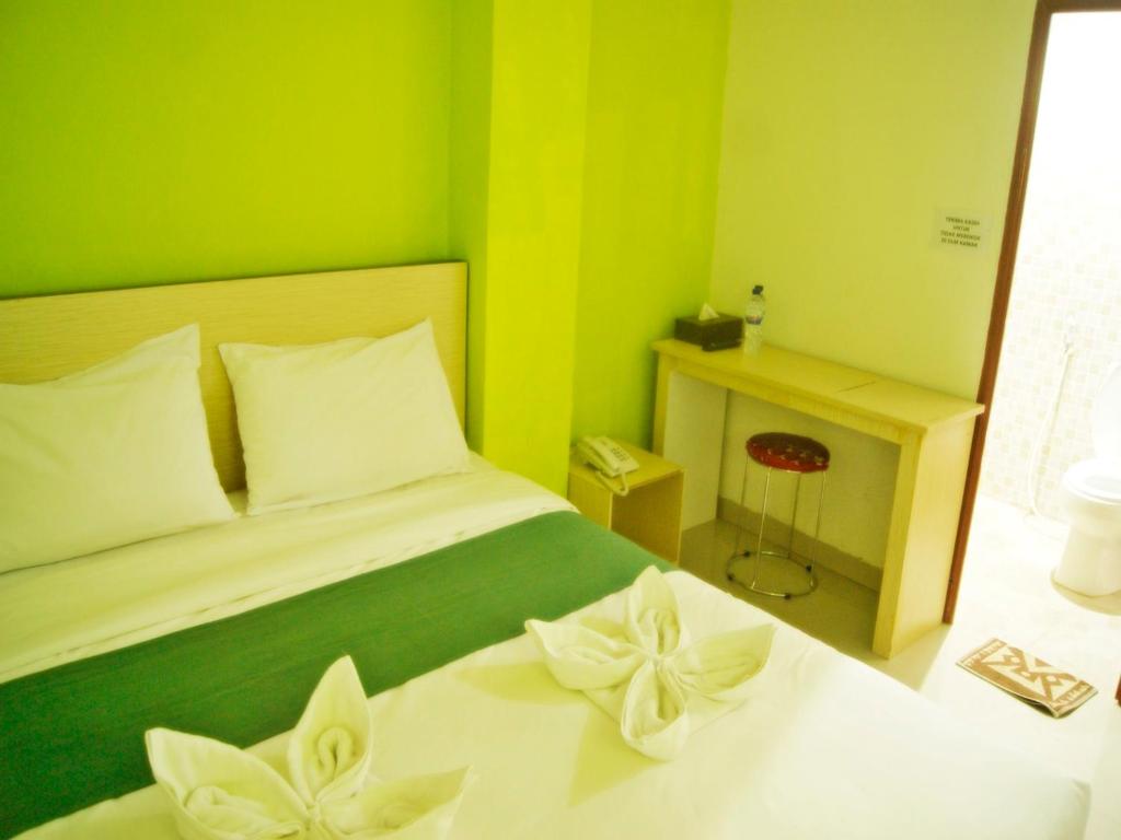 Ένα ή περισσότερα κρεβάτια σε δωμάτιο στο LEOS Hotel