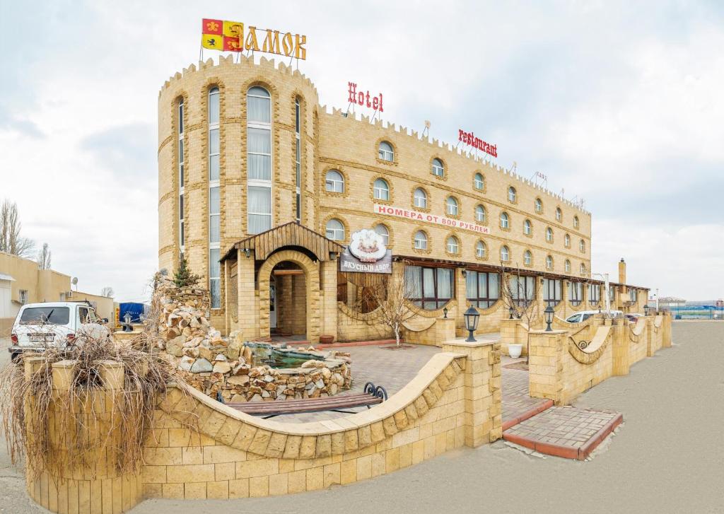 a large building with a sign on top of it at Zamok Hotel in Volgograd