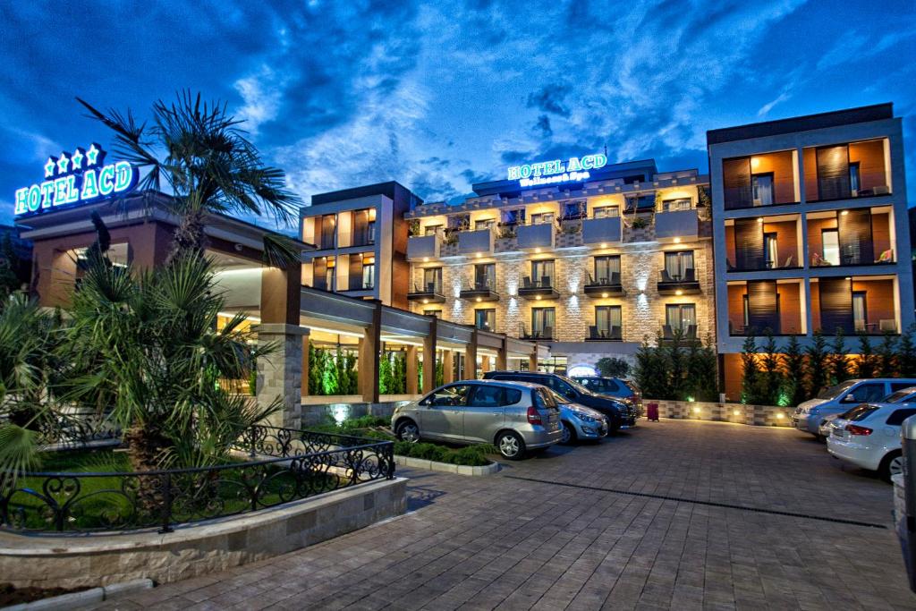 a hotel with cars parked in a parking lot at Wellness & Spa Hotel ACD in Herceg-Novi