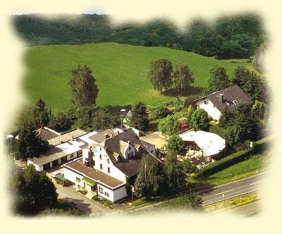an aerial view of a house in a green field at Hotel Waldschloss in Bad Camberg