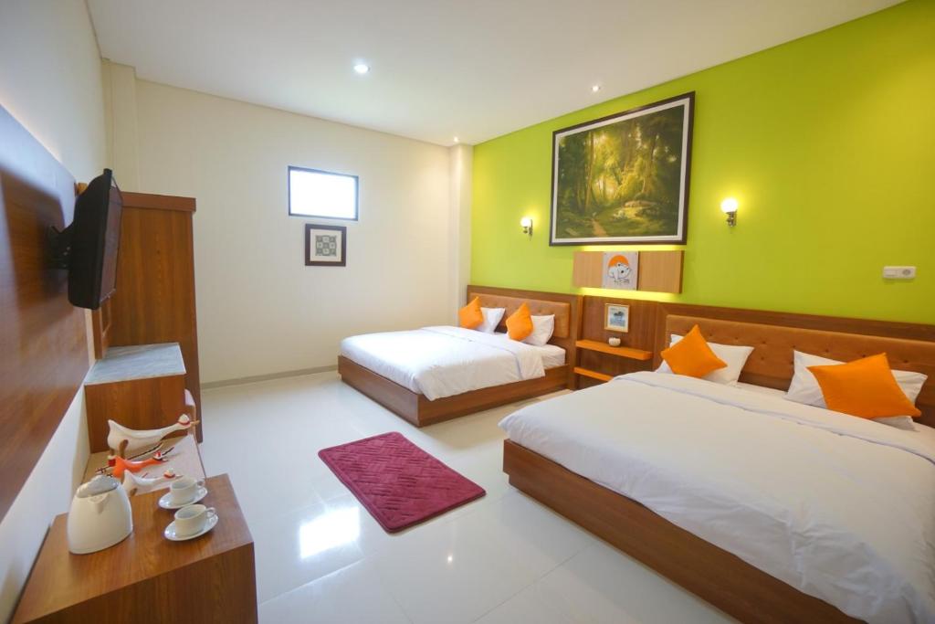 Postel nebo postele na pokoji v ubytování The Cabin Tanjung Hotel Wonosobo