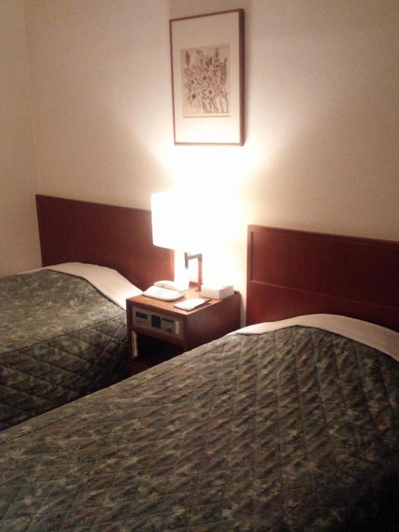 Postel nebo postele na pokoji v ubytování Hotel Danrokan