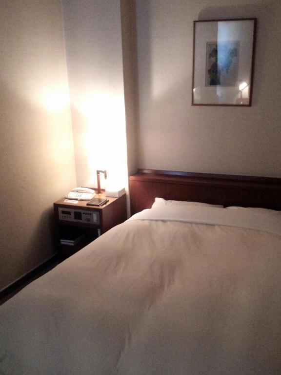 Postel nebo postele na pokoji v ubytování Hotel Danrokan