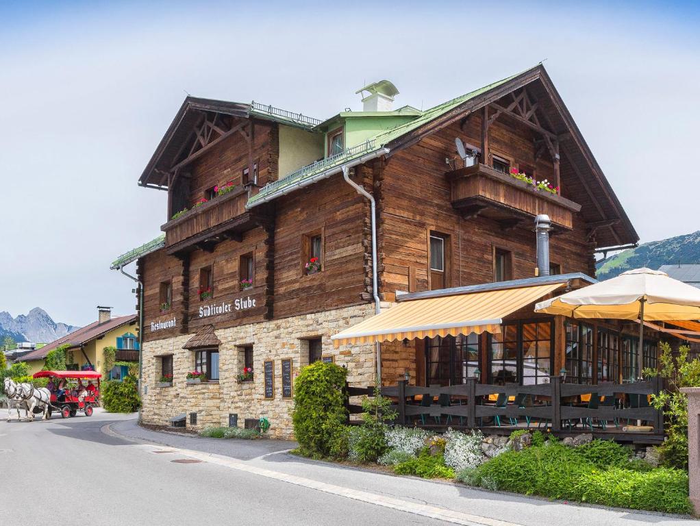 a large wooden building on the side of a street at Südtiroler Stube in Seefeld in Tirol