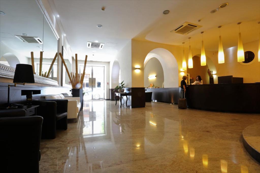 a lobby with couches and tables in a building at Hotel Europa in Foggia