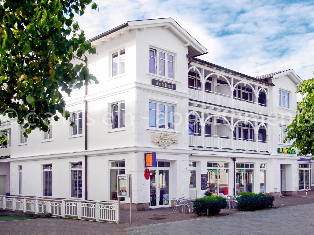 a white building on the corner of a street at Villa Hildegard by Callsen in Binz