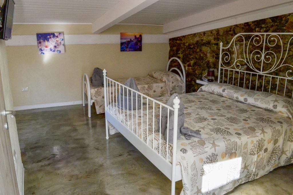 a bedroom with a white bed and a couch at B&B Vistamar in San Nicola Arcella