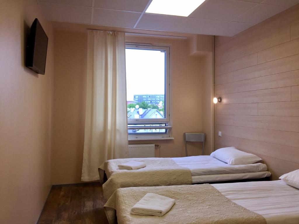 Voodi või voodid majutusasutuse Center Hotel toas