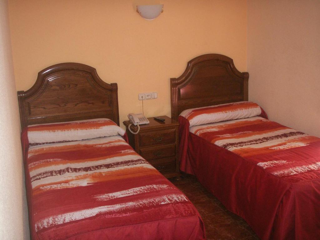 A bed or beds in a room at Hostal La Nava
