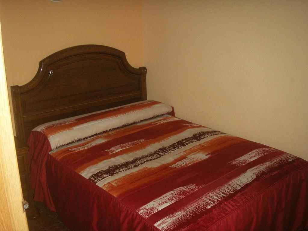 A bed or beds in a room at Hostal La Nava