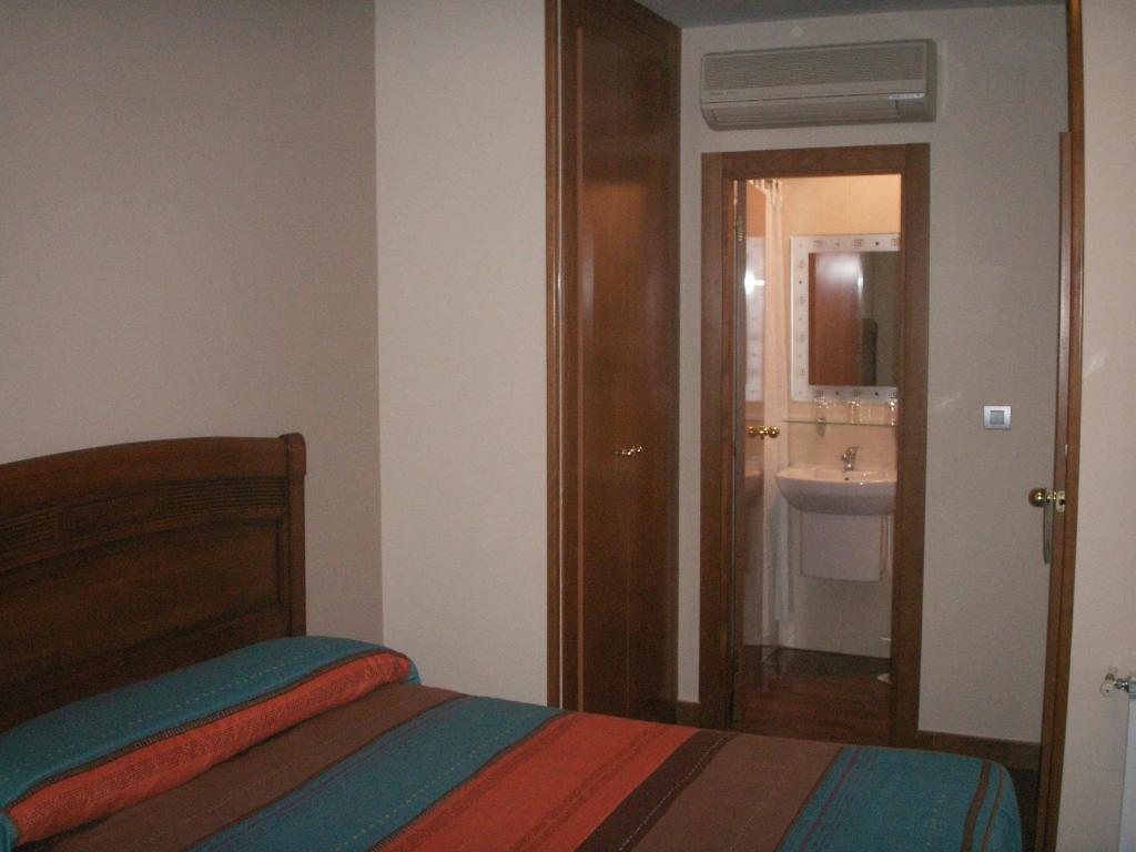 A bed or beds in a room at Hostal La Nava