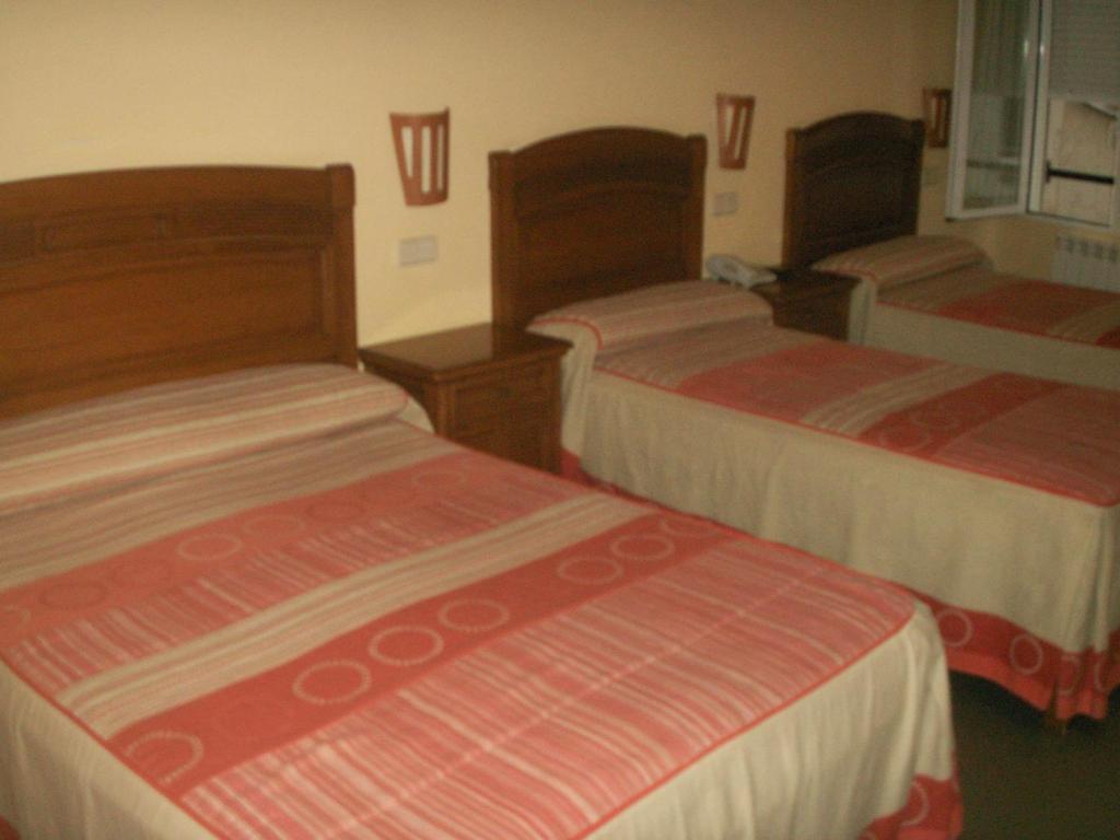 A bed or beds in a room at Hostal La Nava